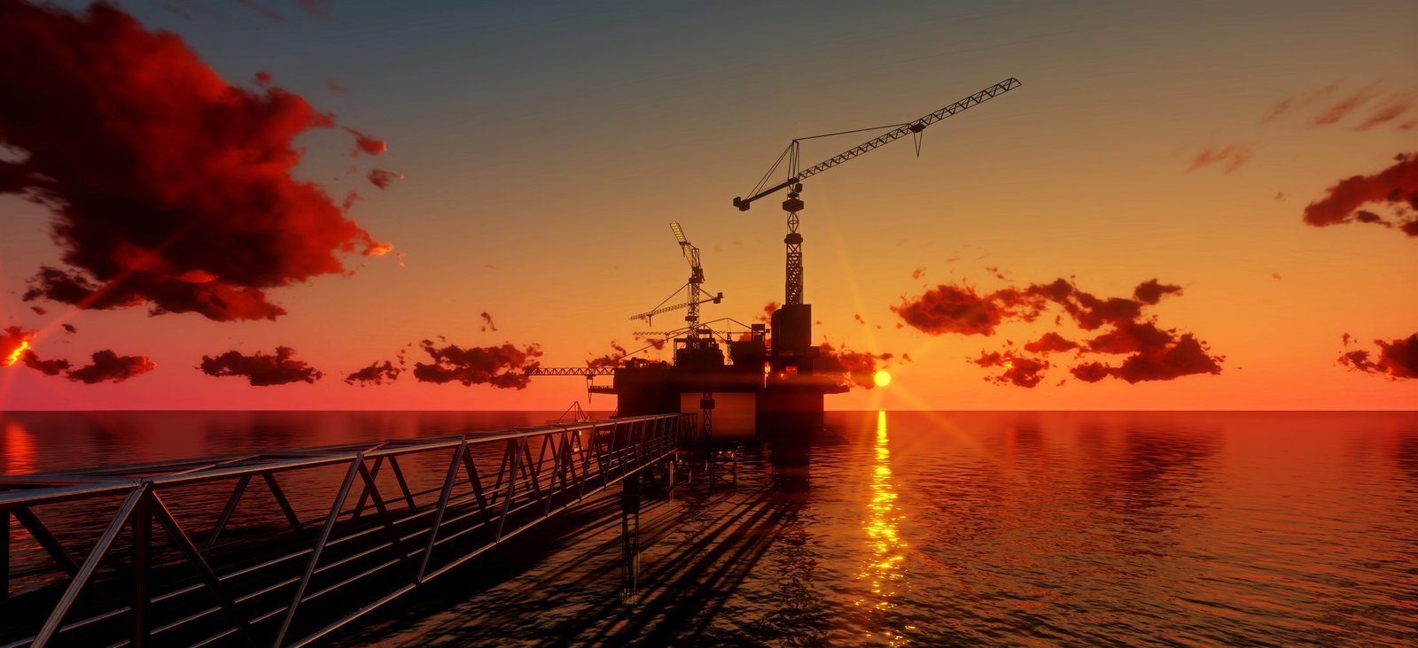 Silueta de una plataforma de perforación en el mar durante el atardecer